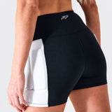 Rear view of a woman wearing black PTP Form Microweighted Shorts with white outer-thigh weight pockets.