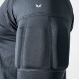 Close-up of a dark gray athletic compression sleeve on a person's upper arm, showing textured padding panels and a small white wing logo near the shoulder.