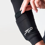 Close-up of a hand opening the forearm weight pocket on a black PTP Motion Microweighted Arm Sleeve.