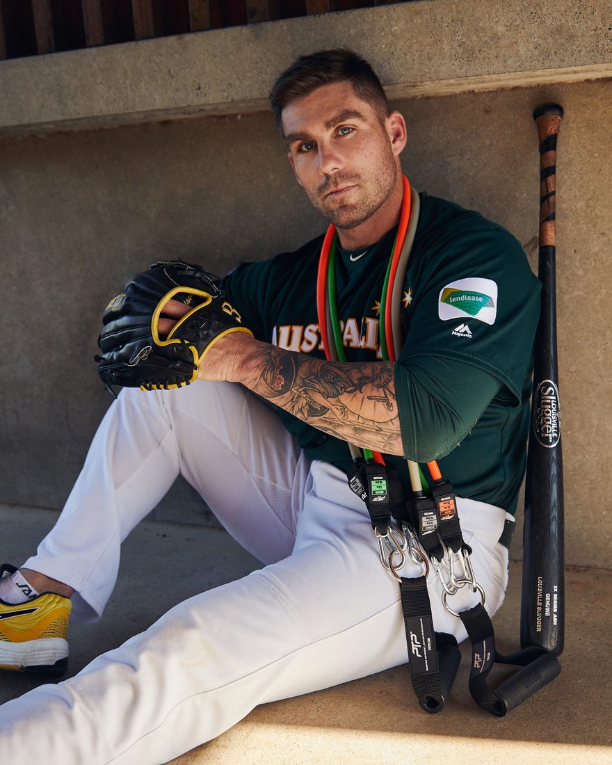 Tim Atherton in the Australian baseball uniform with PTP resistance tubes around his neck